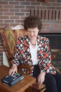 Blind person listening to NFB-NEWSLINE with NLS player