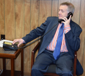 A blind person using a telephone to access nfb-newsline